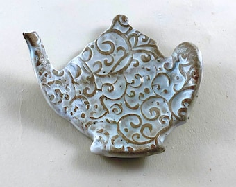 White Textured Teabag Holder in the shape of a Tea Pot.