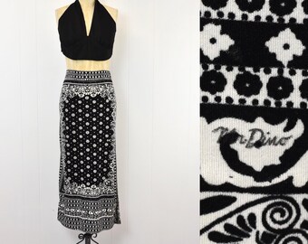 May include: Black and white patterned skirt with a black halter top. The skirt has a white paisley design and the label "Mr. Dino" is visible on the fabric.