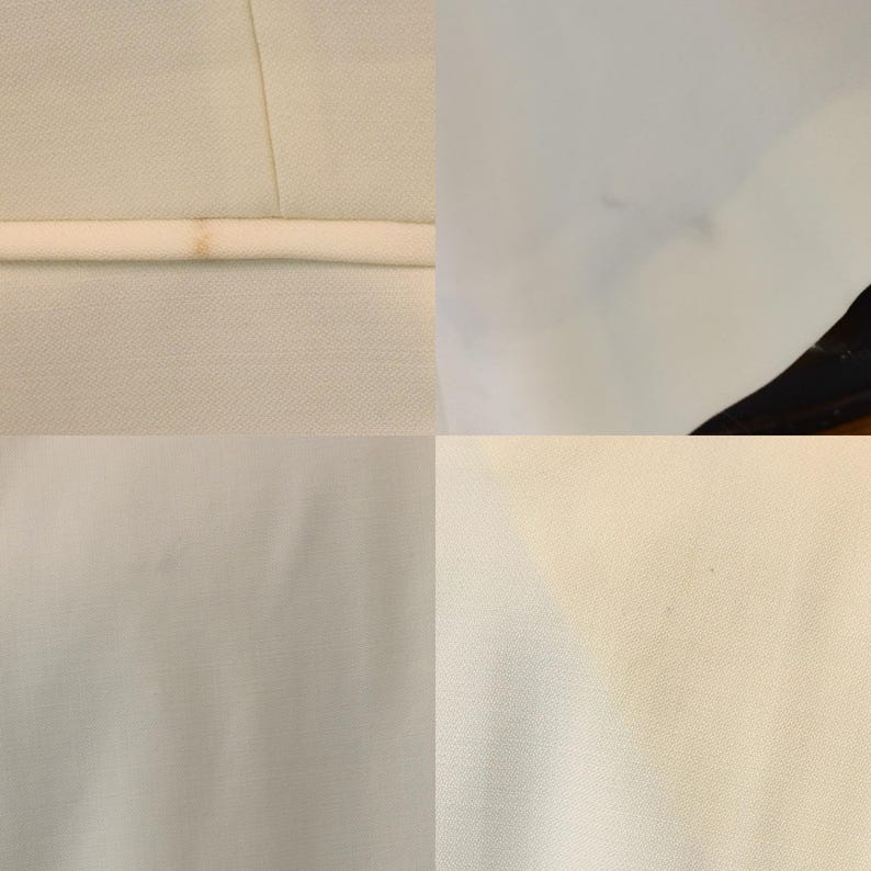 May include: A close-up of a light-colored fabric, possibly a garment, with visible seams and a contrasting white trim. The fabric appears to be slightly textured, with subtle variations in color and some minor imperfections.