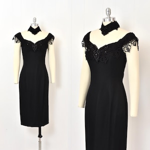 May include: A black cocktail dress with a lace overlay and a black choker necklace. The dress has a fitted silhouette and a sweetheart neckline.