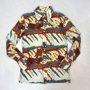 May include: A long-sleeved button-down shirt with a colorful abstract pattern. The design features stylized boats, waves, and lightning bolts in shades of orange, blue, and cream. The shirt has a classic collar and buttoned cuffs.