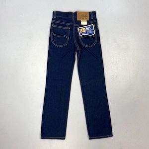 May include: Dark blue denim jeans with the Lee brand label on the back pocket and waistband. The jeans have a classic five-pocket design with yellow stitching and a straight leg. A tag on the back pocket reads "Lee Boys".
