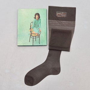 May include: A brown sheer stocking with a diamond pattern and a label that reads "Diamond Full Fashioned Hosiery".