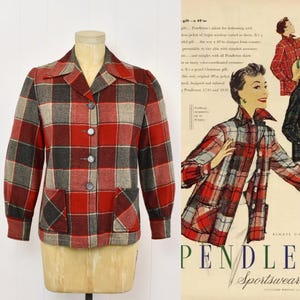 May include: A long-sleeve jacket featuring a red, grey, and black plaid pattern with a pointed collar, four front buttons, and two patch pockets. The jacket is displayed on a mannequin next to a vintage advertisement illustration of the same garment.