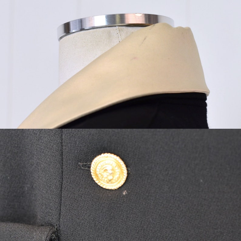 May include: A black blazer with a large gold button and a beige collar.