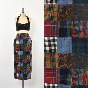 May include: A patchwork skirt with a variety of plaid and paisley patterns in shades of blue, red, brown, and black.