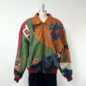 May include: A multi-colored leather jacket with a geometric pattern. The jacket is brown, green, red, blue, and white. It has a zipper closure and a stand-up collar.
