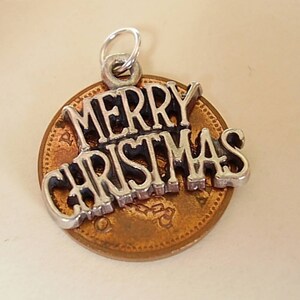May include: Silver charm with the words "Merry Christmas" on a copper penny.