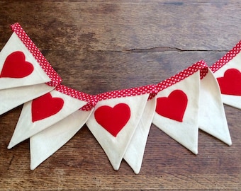 Valentine’s Bunting, big red felt appliqué hearts on natural calico cotton fabric on red and white polka dot tape.