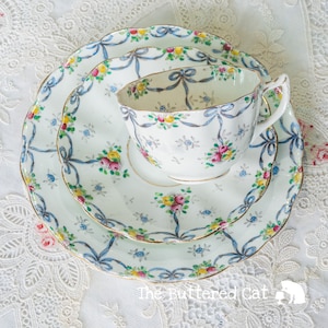 Antique English bone china tea trio with hand decorated ribbon bows and swags