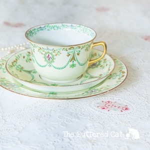 Antique hand-decorated English bone china tea trio, ribbon bows, swags, fleur de lis, cameo