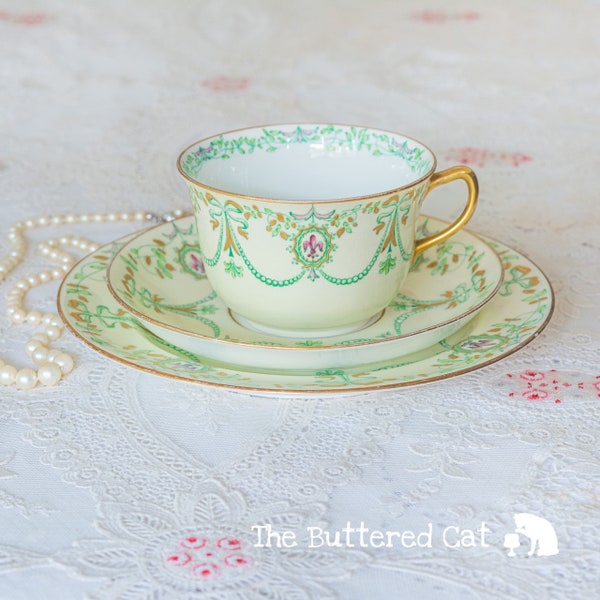 Antique hand-decorated English bone china tea trio, ribbon bows, swags, fleur de lis, cameo