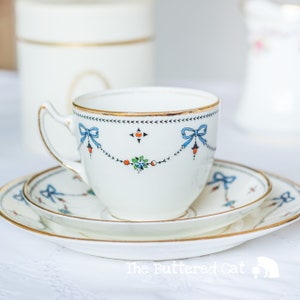 Charming antique art deco English china tea trio, hand-decorated blue ribbon bows, swags