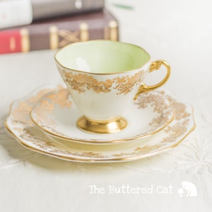 Vintage cream and gold English bone china tea trio with pastel green interior, Foley china