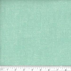 May include: A close-up of a light blue fabric with a subtle textured pattern. The fabric has a slightly rough, linen-like feel.
