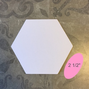May include: White hexagon-shaped craft blank measuring 2 1/2 inches across.