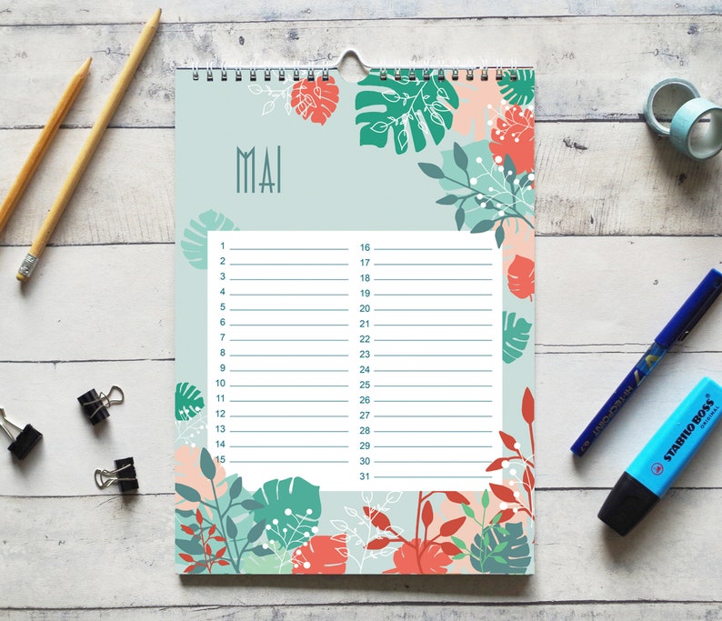 May include: A wall calendar page for the month of May featuring a light blue background with a botanical pattern of coral and dark green leaves. The center contains a white grid with numbered lines from 1 to 31 for daily planning entries.