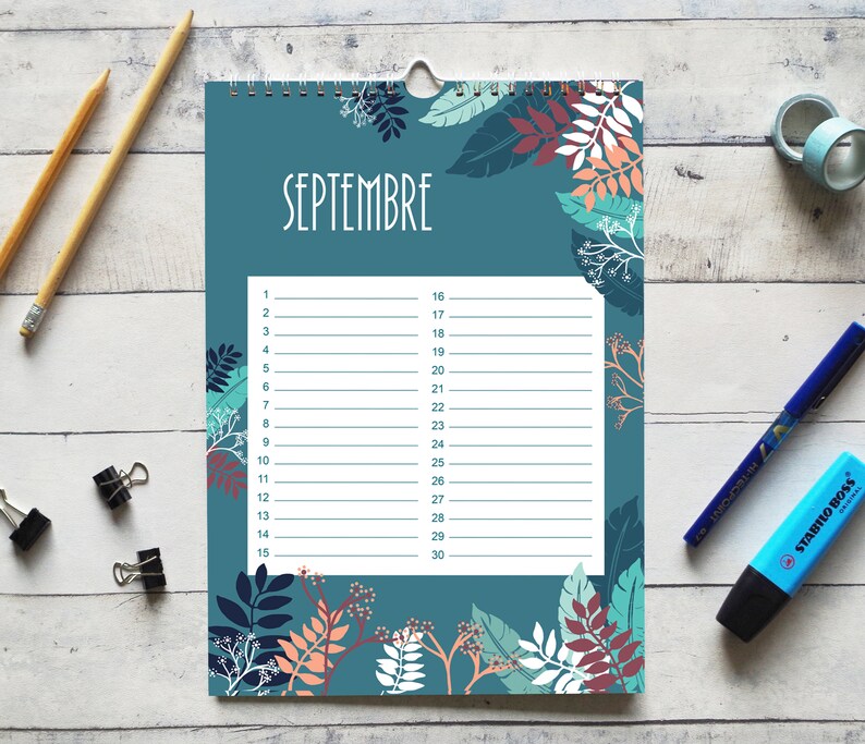 May include: A wall calendar page for September featuring a teal background with a botanical pattern of leaves and branches in shades of dark blue, peach, and white. The center contains a white rectangular area with lines for dates 1 through 30.