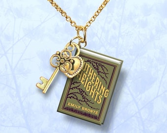 May include: Gold necklace with a key charm and a miniature book charm. The book charm features the title "Wuthering Heights" by Emily Brontë.