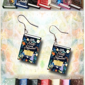 May include: Miniature book earrings featuring the cover of "Pride and Prejudice" by Jane Austen, with a navy blue background and floral accents. Additional miniature book charms include "Anne of Green Gables" and "Narnia".