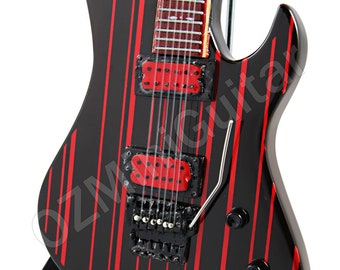 May include: Black electric guitar with red stripes, a black pickguard, and a silver tremolo bar. The guitar is on a black stand.