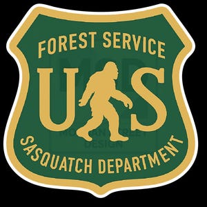 May include: A green and gold shield-shaped sticker with the text "FOREST SERVICE" at the top. The letters "U" and "S" are in gold, with a gold silhouette of a Sasquatch walking between them. The text "SASQUATCH DEPARTMENT" is at the bottom.