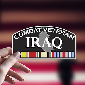May include: Black and white sticker with the text "Combat Veteran Iraq" and a gray outline of the country of Iraq. The sticker has a row of colorful ribbons at the bottom.