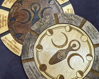 May include: Two wooden circular wheel-shaped calendars with the names of the eight pagan holidays and the dates of the solstices and equinoxes. The calendars are decorated with a stylized female figure and moon phases.