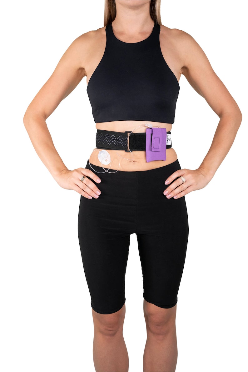 A model, whose belly button and lower rib cage are exposed, is wearing a Pumpcases™ lavender purple, adjustable, insulin pump waist belt, compatible with t:slim X2 made for Diabetics. This belt is placed above her belly button.