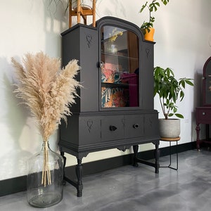 Antique black china cabinet with black agate stone slice handles.