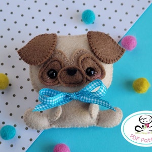 May include: A felt pug dog toy with brown ears, a blue and white checkered bow, and black eyes. The toy is sitting on a blue surface with white polka dots.