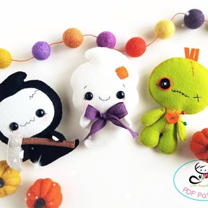 May include: Three felt Halloween character patterns: a ghost, a grim reaper, and a voodoo doll. The patterns are on a white background with a string of colorful felt balls and small felt pumpkins.