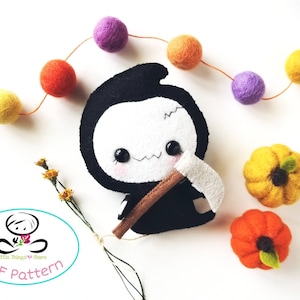 May include: A black and white felt plush toy of the Grim Reaper holding a brown axe. The toy is surrounded by a garland of colorful felt balls and two small felt pumpkins.