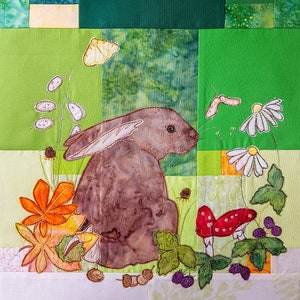 May include: A brown rabbit sits in a green field with a yellow butterfly, orange flowers, and white daisies. There are also red mushrooms and blackberries in the scene.