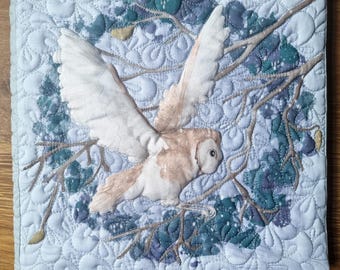 Printed sewing pattern to make square quilted book cover using fabric panel.