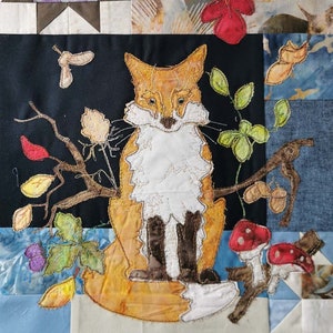 May include: A patchwork quilt with a fox applique in the center. The fox is orange and white with brown legs and is sitting on a branch with leaves and mushrooms. The quilt is made of various fabrics in shades of blue, brown, white, and beige.