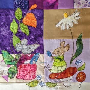 May include: A patchwork quilt featuring two embroidered mice. One mouse is seated near a plant with orange flowers, the other near a large daisy. The quilt has a variety of colors, including purple, green, and tan.