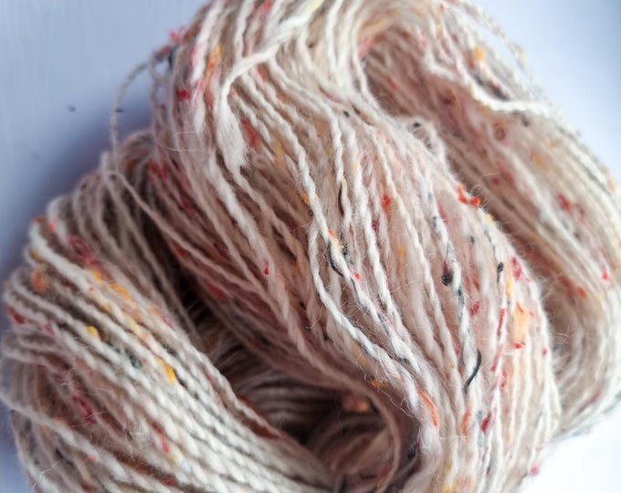 Featured listing image: Handspun wool - double knitting weight - light cream with red yellow black nepps
