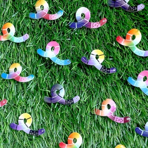 May include: A collection of colourful, whimsical, worm-shaped magnets with different patterns and designs. The magnets are made of a durable material and are perfect for adding a touch of fun to any refrigerator or metal surface.