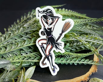 May include: A sticker featuring a cartoon witch with a black dress, purple boots, and a black hat with a white brim. She is holding a broom and flying.