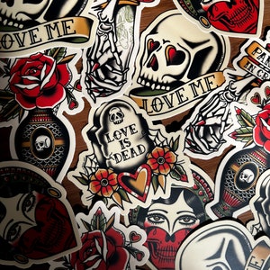 May include: A collection of colorful, vintage-style tattoo flash designs. The designs include skulls, roses, hearts, and a skeleton hand. The text on the designs includes "Partner in Crime", "Love Me", "Love is Dead", and "Partner in Crime".