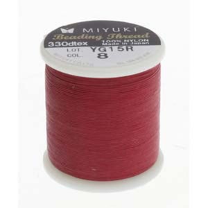 May include: A spool of red Miyuki Beading Thread, 330dtex, 100% nylon, made in Japan. The spool is labelled with the colour code YG15R and the lot number 8.