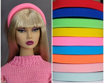 May include: A set of 12 colorful headbands in various colors, including red, blue, green, yellow, pink, orange, light pink, light blue, white, and black. The headbands are made of a soft, stretchy material and are perfect for adding a pop of color to any outfit.