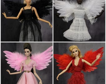 May include: Four dolls with different colored feather wings. The dolls are wearing different dresses. The wings are black, white, pink, and red.