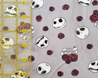 May include: Gray fabric with a repeating pattern of Jack Skellington faces, red roses, and banners that read "MASTER OF FRIGHT". The design is a whimsical, spooky theme.