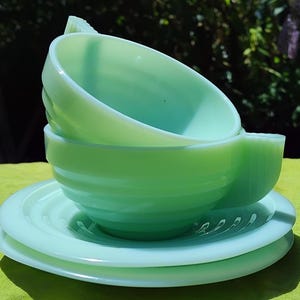 A pair of vintage French Jadite Cups and Saucers Set: Art Deco l, green glass. Tea, coffee, beverage, dining
