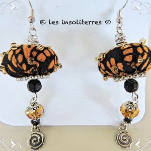 round textile hanging earrings in yellow and black printed fabric embroidered with beads