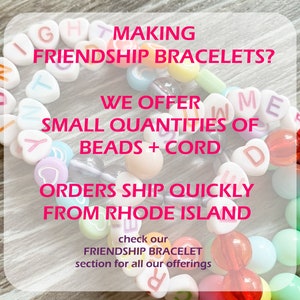 May include: A close-up of colorful heart-shaped beads and round beads strung on a white cord, forming a friendship bracelet. The bracelet spells out "Friendship" and "Love" in white letters. The text "Making Friendship Bracelets? We offer small quantities of beads + cord. Orders ship quickly from Rhode Island. Check our Friendship Bracelet section for all our offerings." is written in pink and white text.
