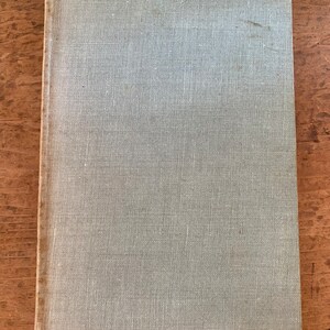 May include: A light blue book with a textured linen cover.