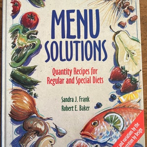 Puede incluir: Un libro de cocina titulado "MENU SOLUTIONS: Recetas en cantidad para dietas regulares y especiales" de Sandra J. Frank y Robert E. Baker. La portada presenta una ilustración colorida de diversas frutas, verduras y mariscos.
